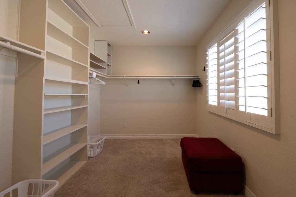 Spacious walk-in closet with ample shelving and natural light.