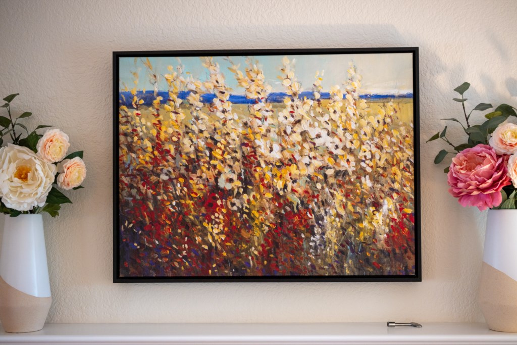 Vibrant floral artwork enhances the cozy living space ambiance.