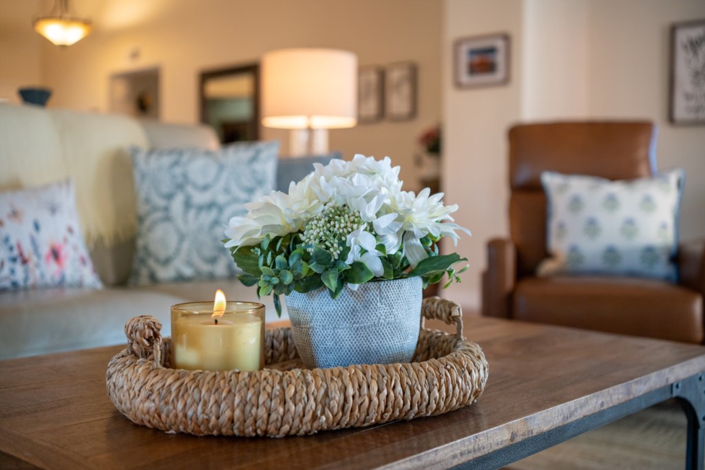 Cozy living room with soft lighting and a welcoming floral centerpiece.