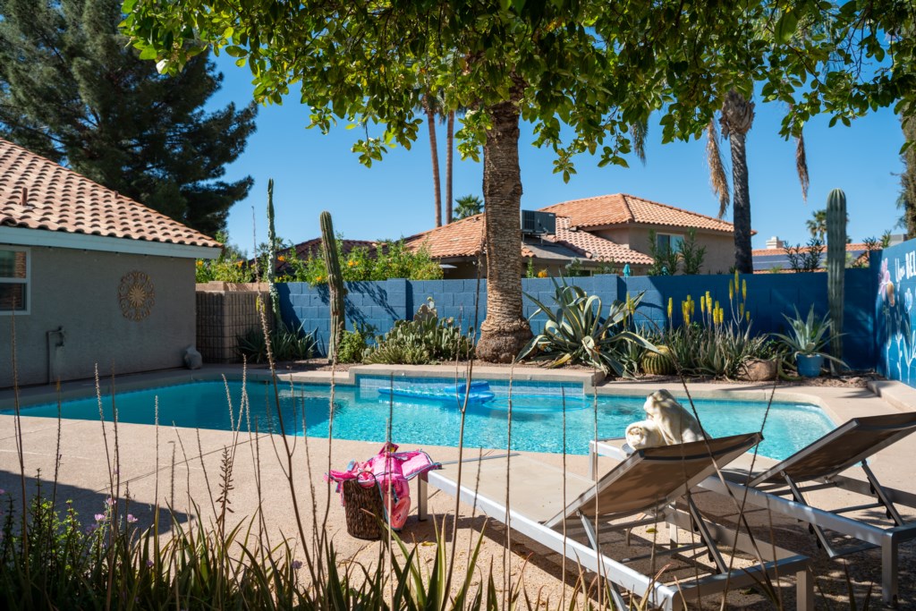 Relax by the private pool surrounded by lush greenery and desert charm.