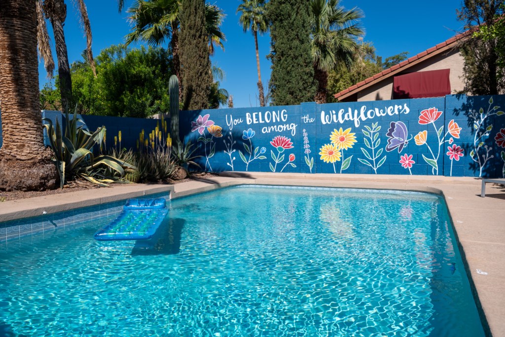 Relax by the vibrant mural at this private pool oasis.