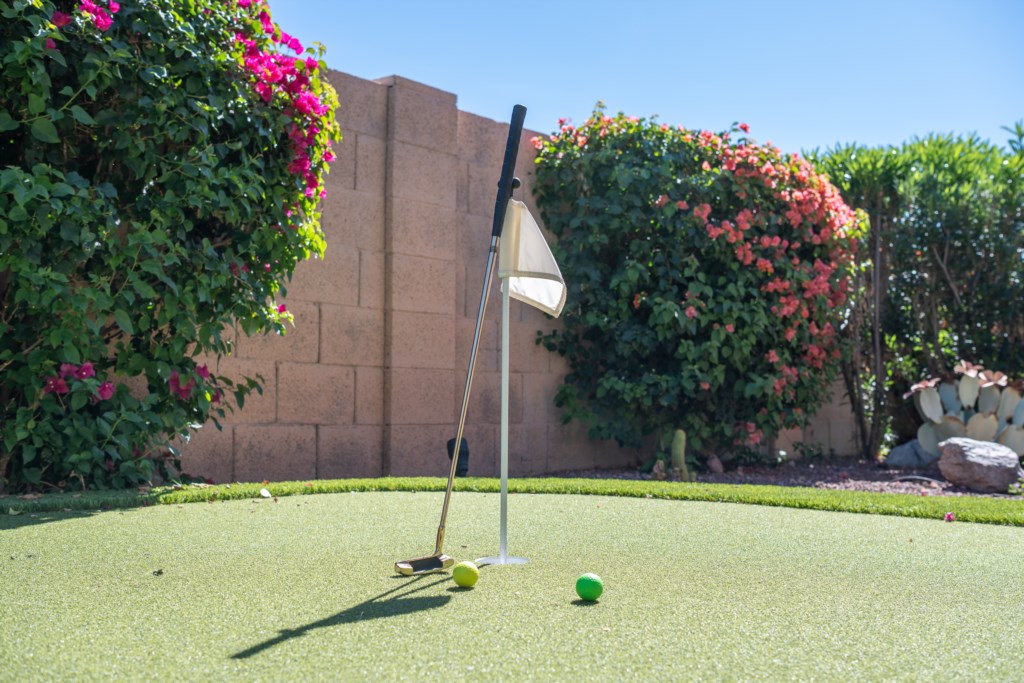 Private mini-golf course surrounded by lush, colorful gardens for relaxing outdoor fun.