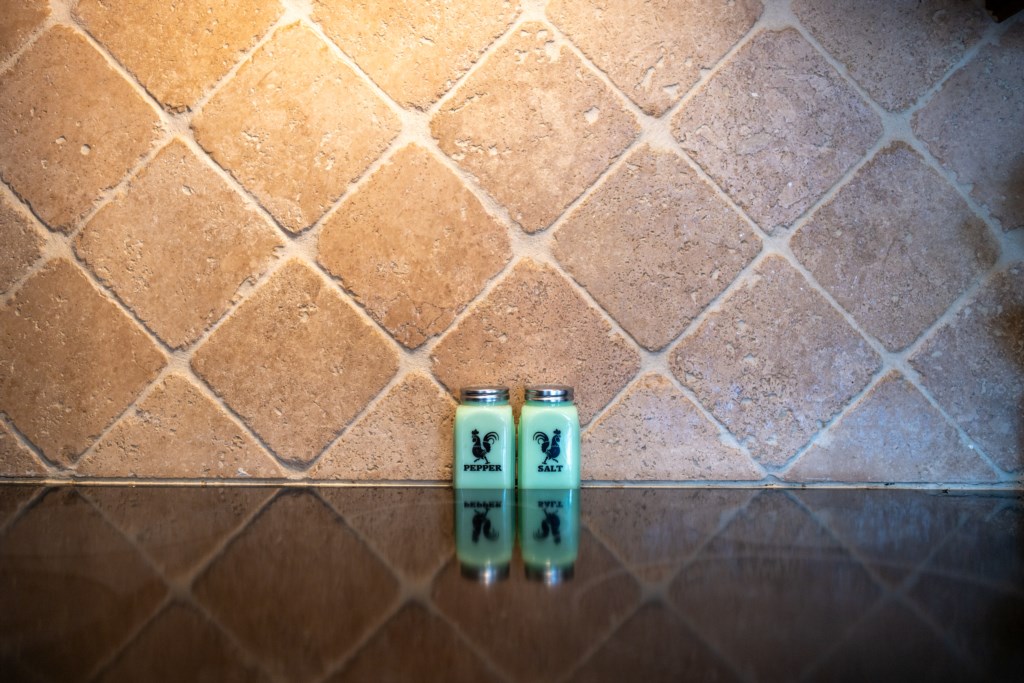 Elegant kitchen backsplash with charming salt and pepper shakers.