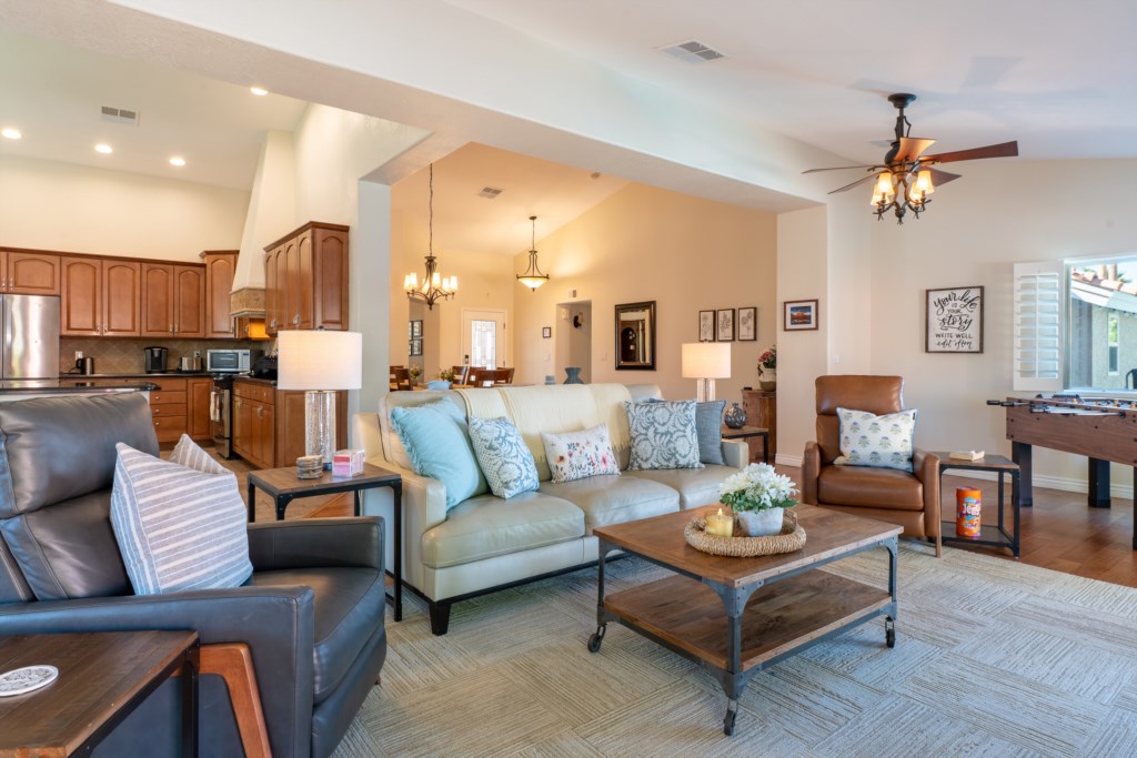 Spacious living area with cozy seating and a foosball table for fun family gatherings.