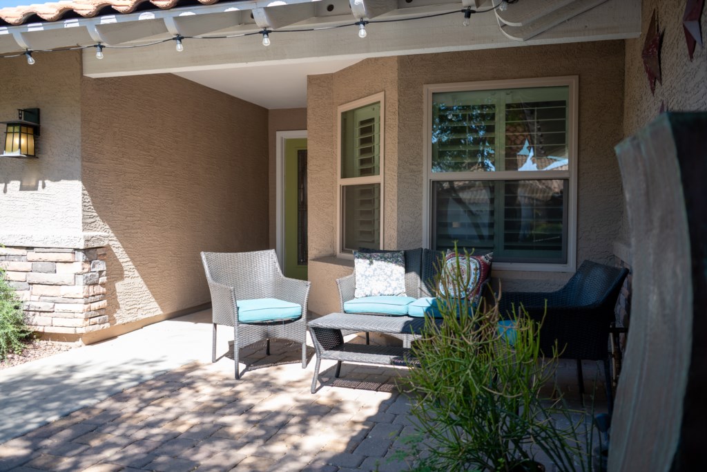 Charming patio with cozy seating, perfect for morning coffee or evening relaxation.