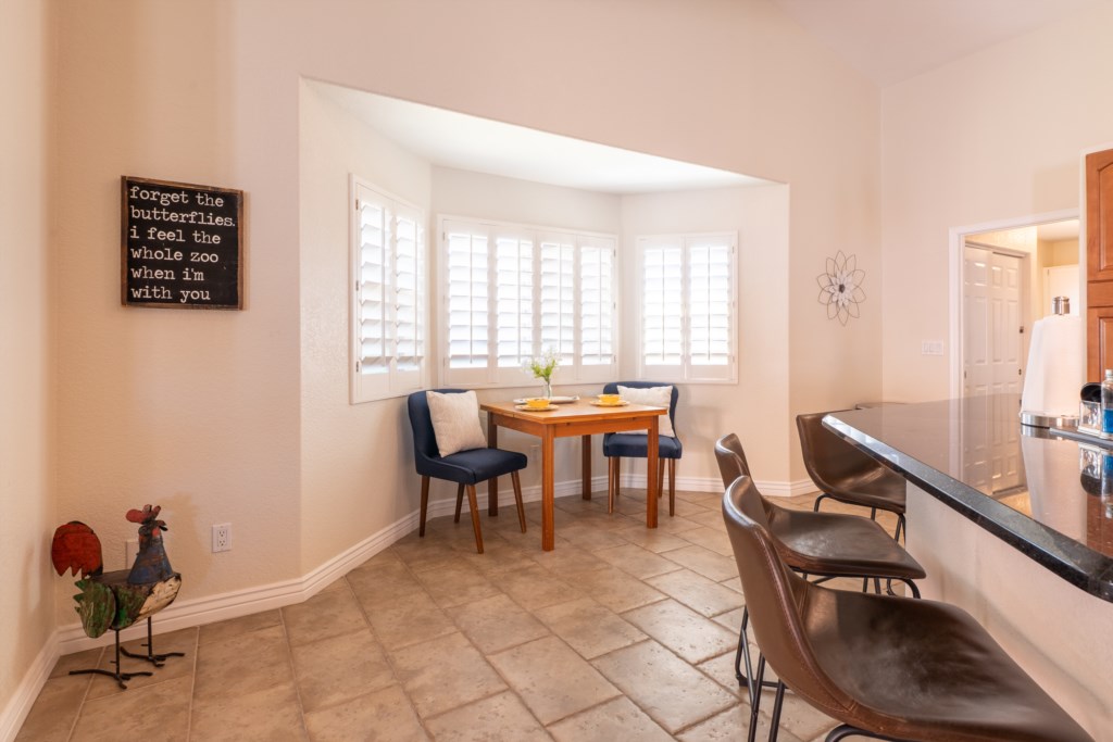 Cozy breakfast nook with natural light and comfortable seating for two.