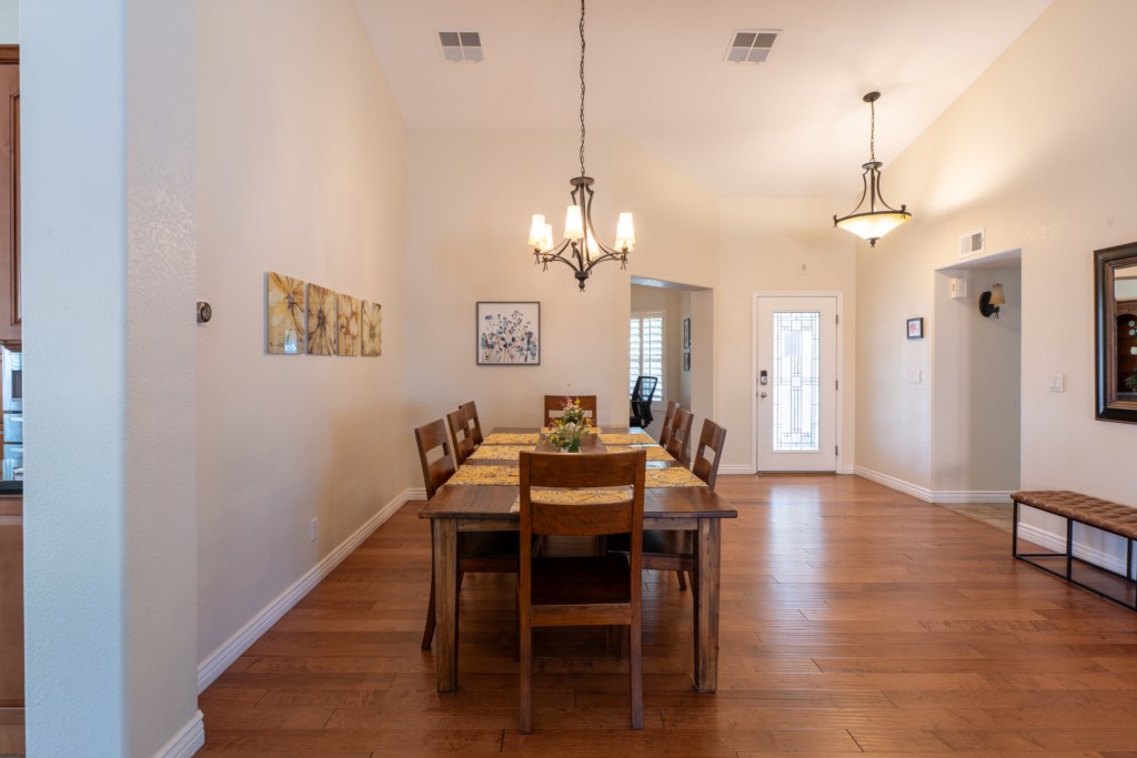 Elegant dining area with seating for eight and warm lighting for intimate gatherings.