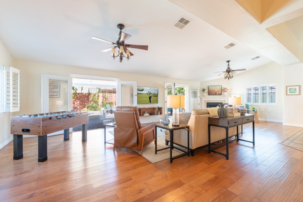 Spacious living room with foosball table and cozy seating, perfect for family gatherings.