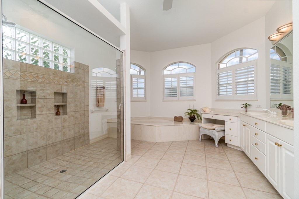 Spacious en-suite bathroom featuring a large walk-in shower and a separate soaking tub, ideal for relaxation.