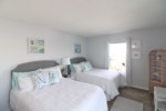 The second bedroom boasts two full size beds, as well as a secondary access point to the upper balco