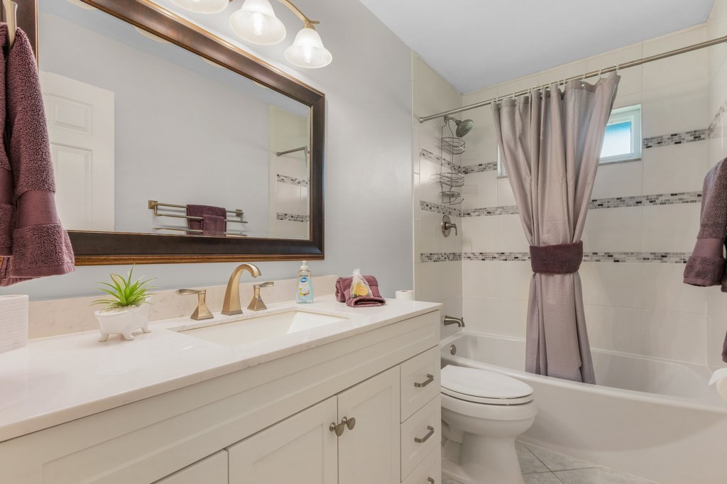 Modern bathroom with sleek fixtures and a refreshing shower, perfect for unwinding after a long day.