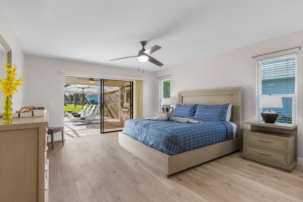 Spacious master bedroom with direct access to the pool and stunning outdoor views.