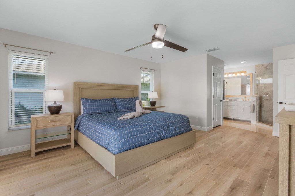 Spacious master bedroom with ensuite bathroom and cozy, modern decor.