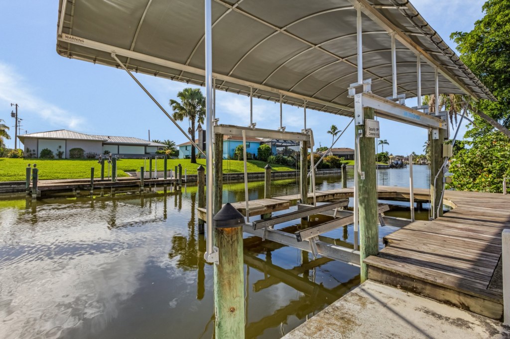 Private boat dock with lift, offering easy access to the canal for boating adventures.