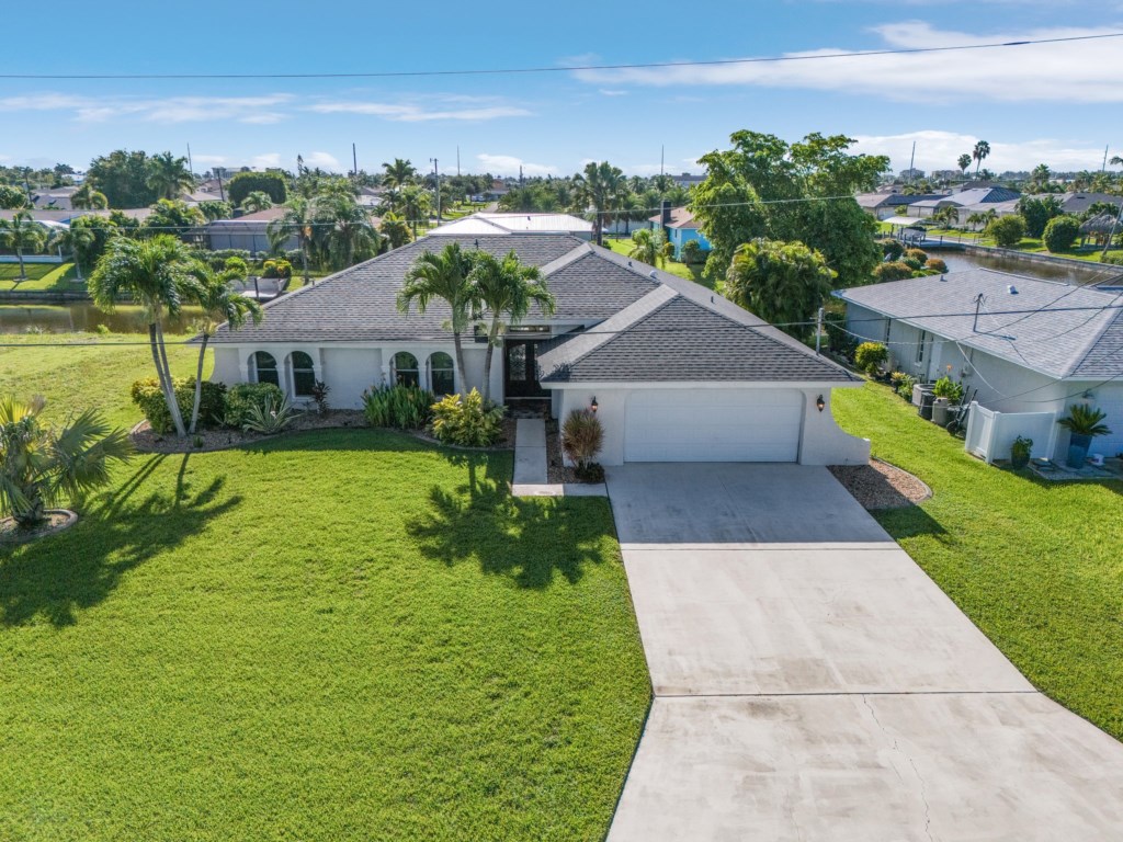 Spacious driveway and well-maintained lawn, welcoming you to your waterfront retreat.