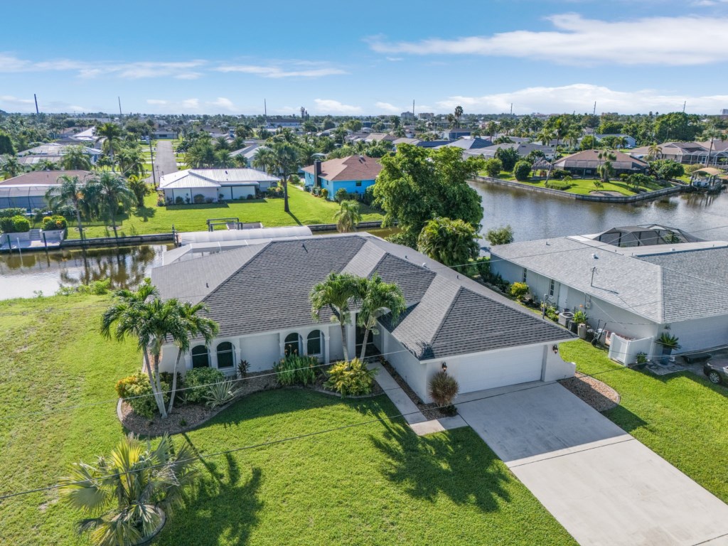 Spacious waterfront home with stunning canal views and lush landscaping.