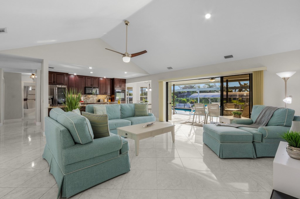 Bright, open-concept living space with modern decor and poolside access.