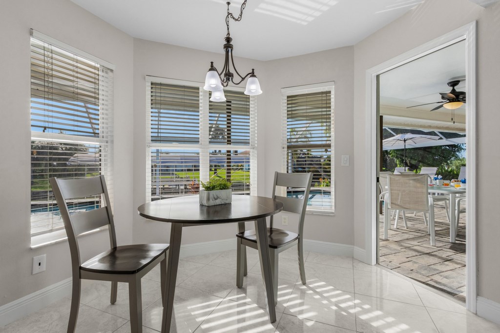 Cozy breakfast nook with natural light and pool views, perfect for morning coffee.