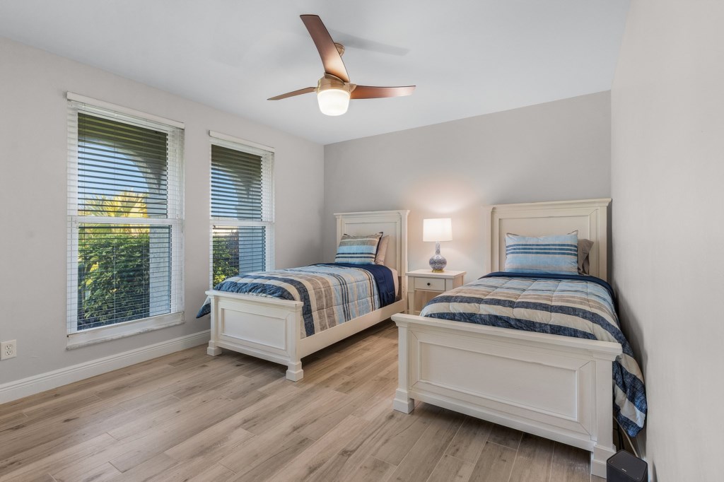 Charming bedroom with twin beds, perfect for a restful night’s sleep.