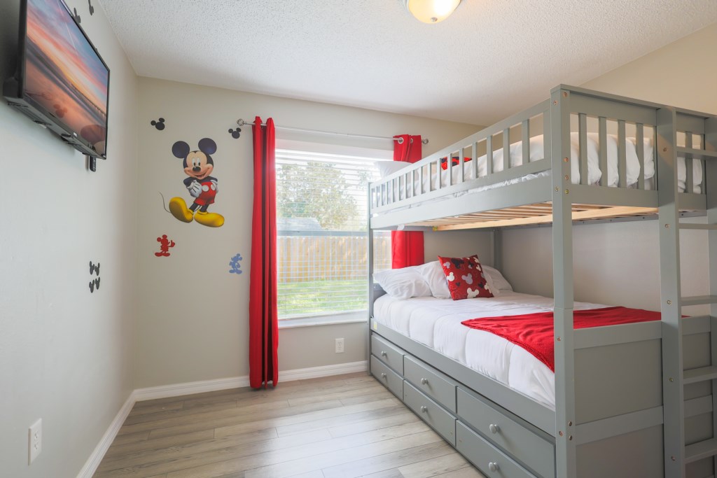 Mikey Mouse Theme room with two full size beds.