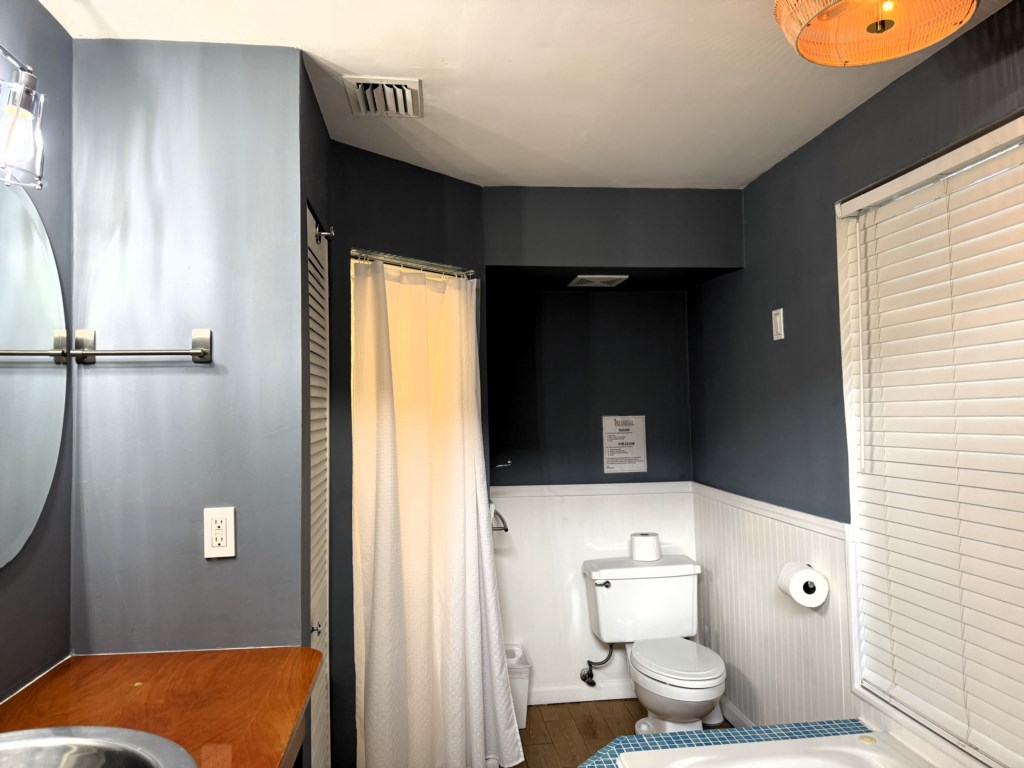 Master bathroom contains product dispensers, a hand soap, cosmetic towels, 2 toilet paper rolls