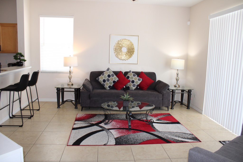 Spacious family room featuring two comfortable sofas and a flat-screen TV, perfect for relaxing after a day at the golf 