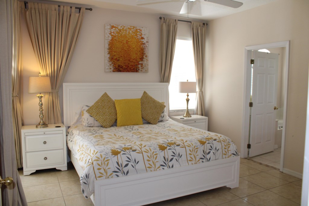 Luxurious master bedroom featuring a spacious King-size bed and convenient direct access to the private pool area.