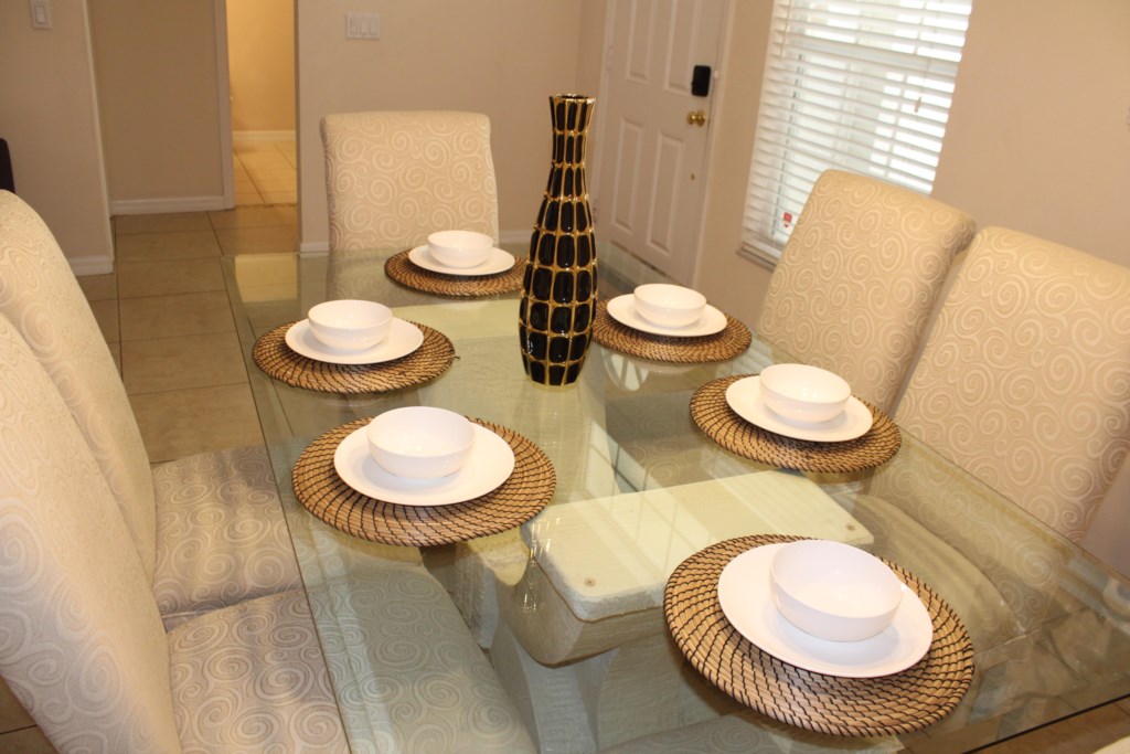 Upon entering the home, you are greeted by an inviting guest seating area and a formal dinning space for 6.