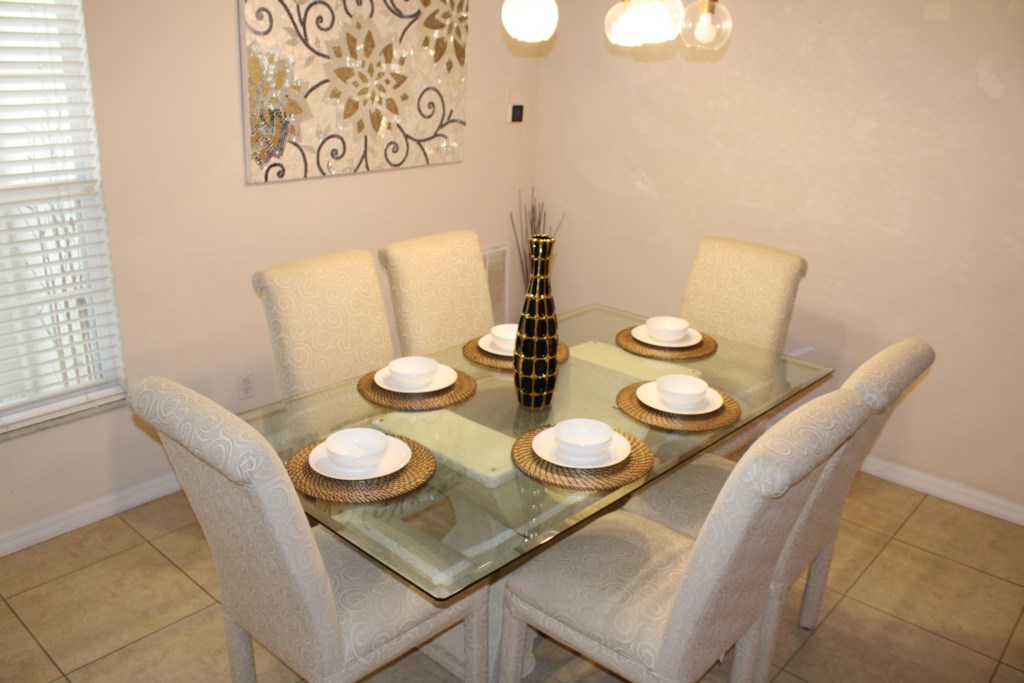 Formal dining area featuring comfortable seating for 6 guests.
