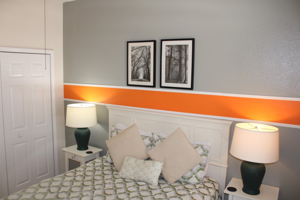 Queen bedroom featuring a spacious closet and a flat-screen television for your convenience.