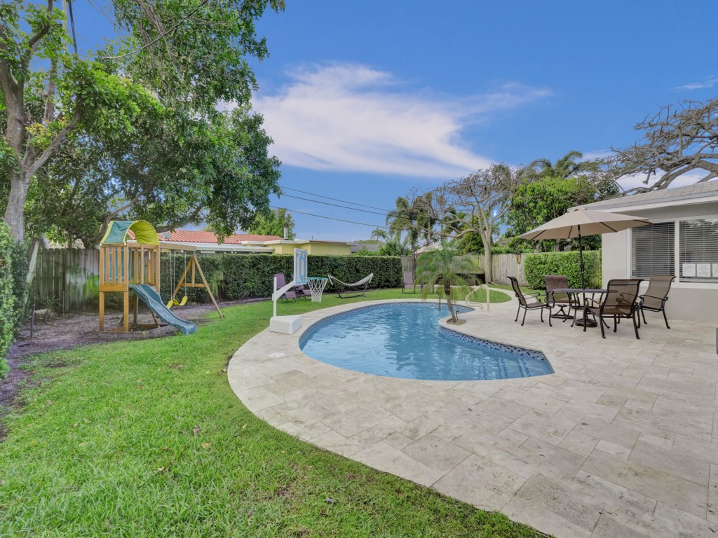 Spacious backard features Dining area, Playground, Pool Hoop, Hammock, BBQ, and Sitting Area