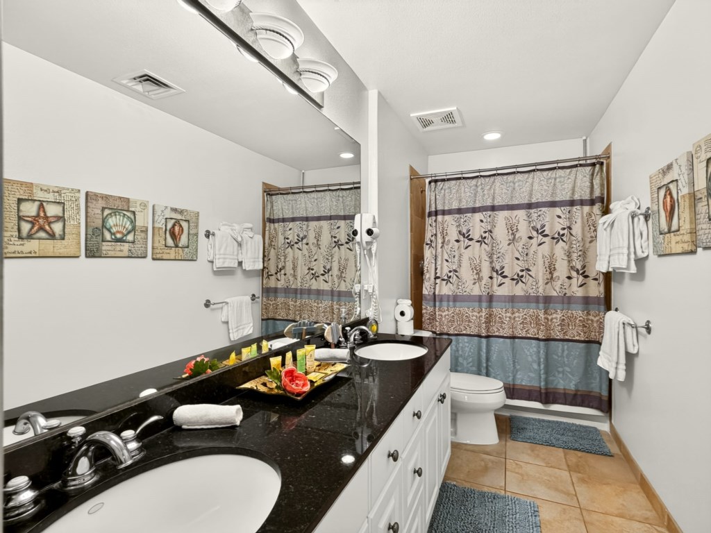 Primary Bathroom with Double Sinks and Tub Shower