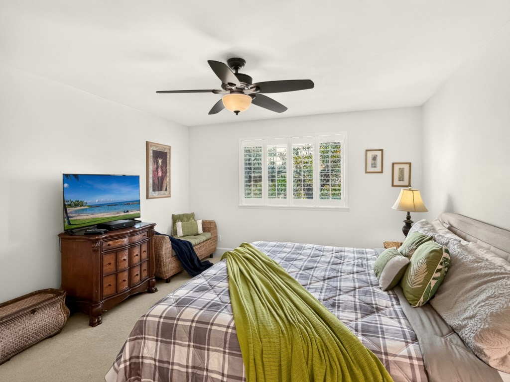 Primary Bedroom with King Bed, Ceiling Fan, and Smart TV