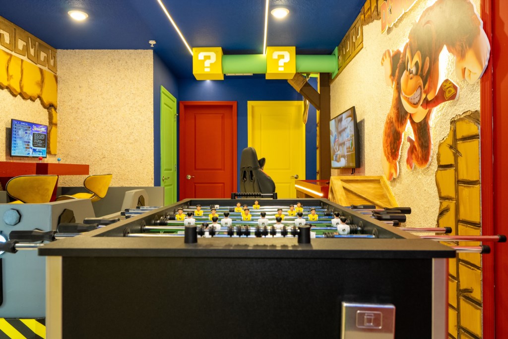 Donkey themed game room with arcades and foosball table