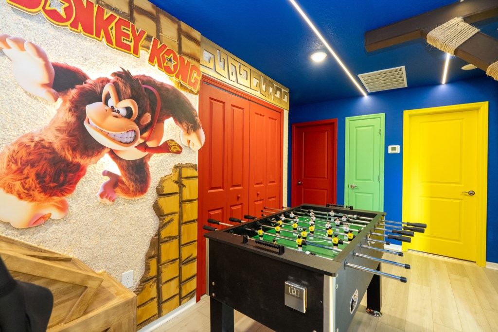 Donkey themed game room with arcades and foosball table