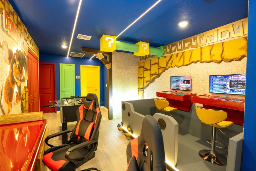 Loft converted to a game room with arcade & foosball.