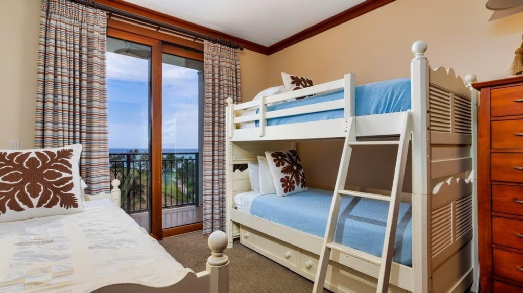 Bedroom three  with twin bunk beds, one full bed and ocean view.