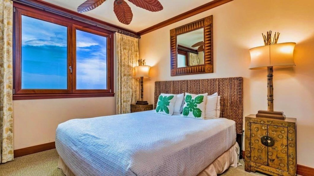 Bedroom two with queen bed and ocean view.