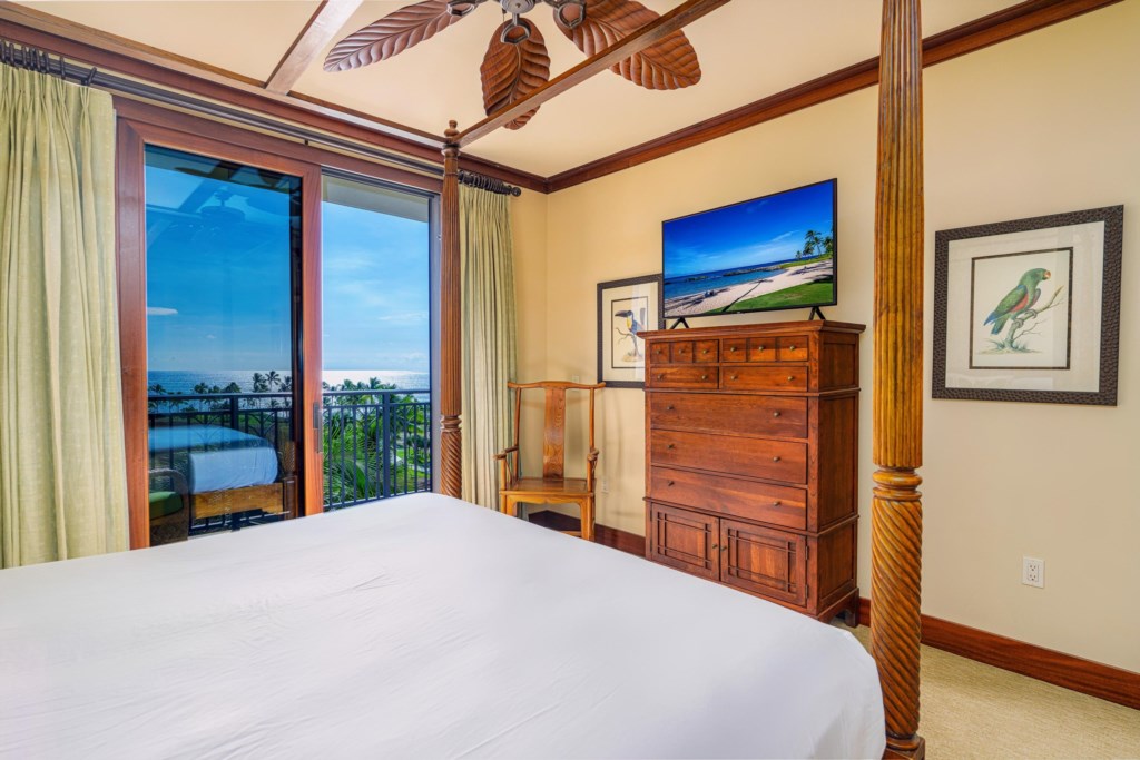 Primary bedroom with ocean views and a smart TV.