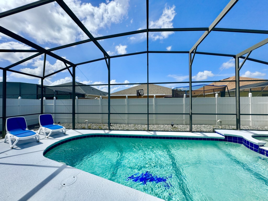 Sparkling pool in a screened-in enclosure for a refreshing swim anytime.