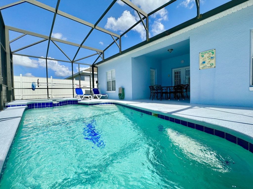 Private pool with a shaded patio area, perfect for relaxing outdoors.