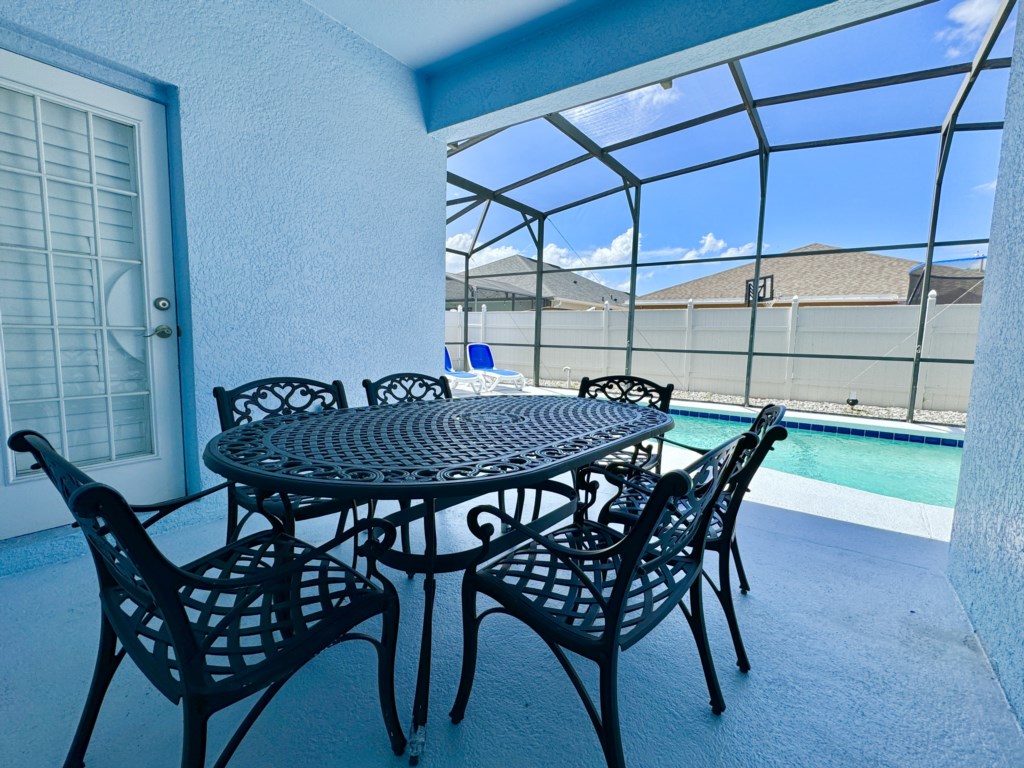 Shaded outdoor dining area next to the pool, perfect for al fresco meals and relaxation.