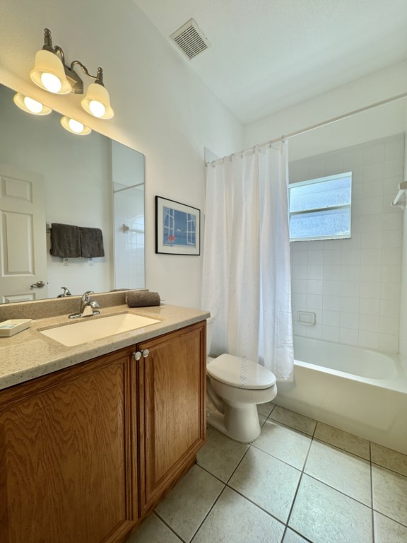 Clean and bright bathroom with a full shower and tub for your convenience.