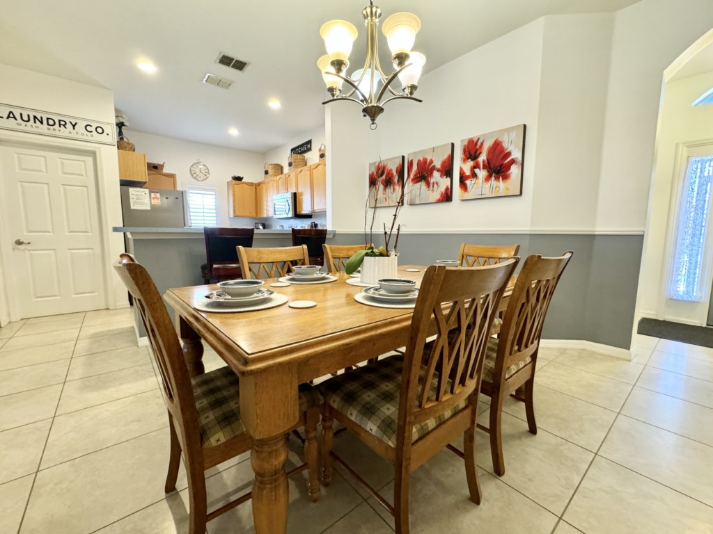 Elegant dining space adjacent to a fully equipped kitchen for your cooking needs.