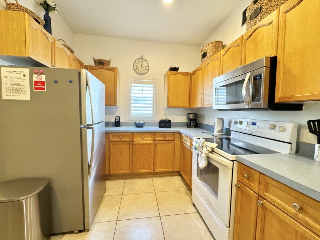 Fully equipped kitchen with modern appliances, ready for home-cooked meals.