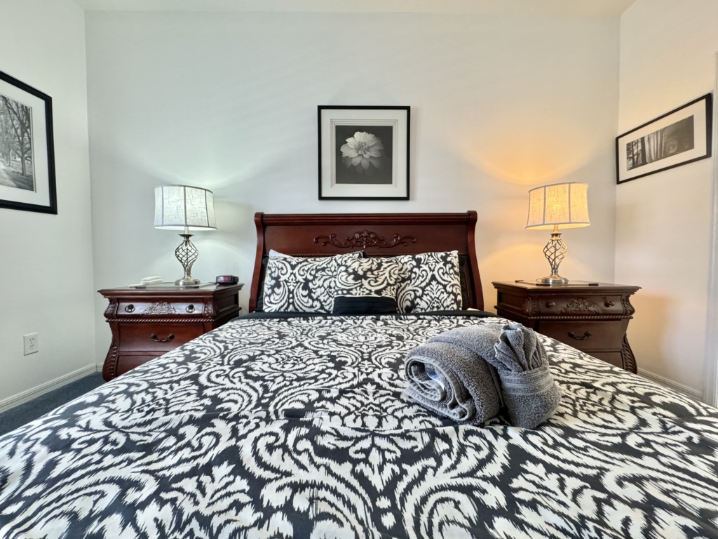 Stylish master bedroom with plush bedding and elegant decor for ultimate comfort.