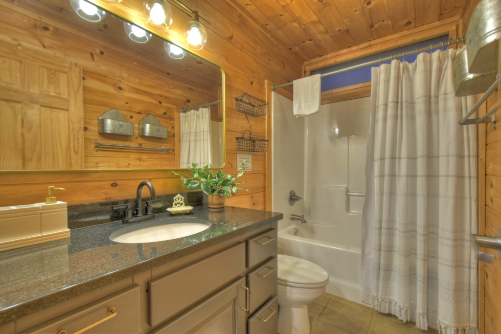 Bathroom on the main level that sits between the king and queen bedrooms 