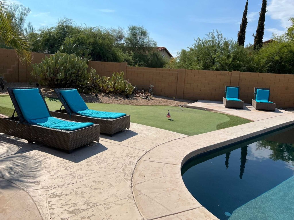 Relax by the pool with comfy sun loungers and a private putting green.