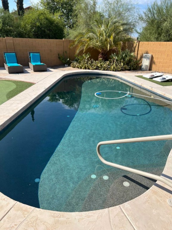 Inviting backyard pool with lounge chairs, perfect for a sunny retreat.