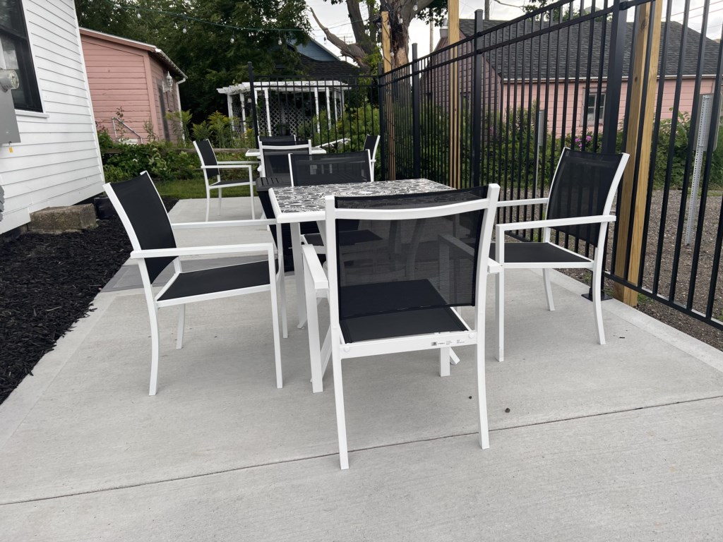 Victorian outdoor common area space with grill and fire pit